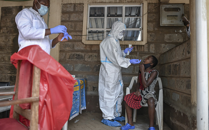 FILE: A young girl waits to be tested during mass testing for COVID-19 coronavirus provided free of charge by the Kenyan government in the Kibera slum in Nairobi, Kenya, on 18 October 2020. Picture: AFP