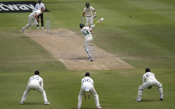 South Africa's Dean Elgar (C) plays a shot delivered by England's Stuart Broad (top L) during the fourth day of the second Test match between South Africa and England at Newlands Stadium in Cape Town on 6 January 2020. Picture: AFP