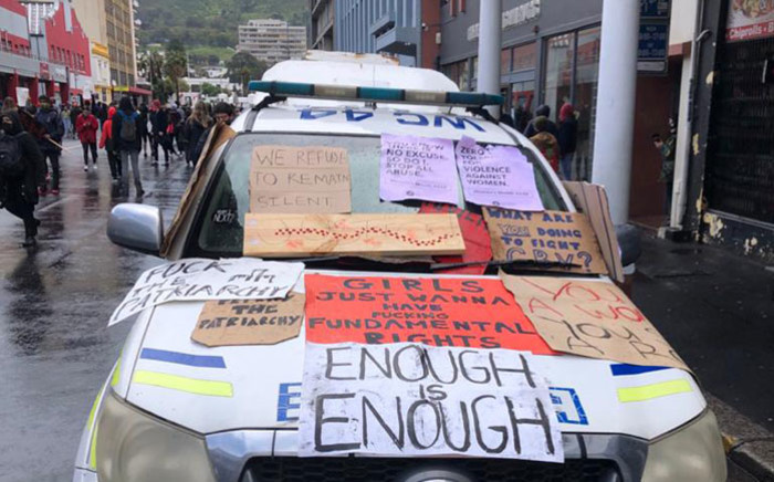 A police vehicle is covered with placards during an anti-gender-based violence protest in front of Parliament in Cape Town on 29 August 2020. Picture: Courtney Savage