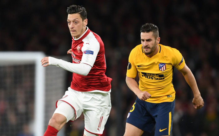 Arsenal's Mesut Ozil (left) in action during the Europa League first leg semi-final match against Atletico Madrid on 26 April 2018. Picture: @MesutOzil1088/Twitter