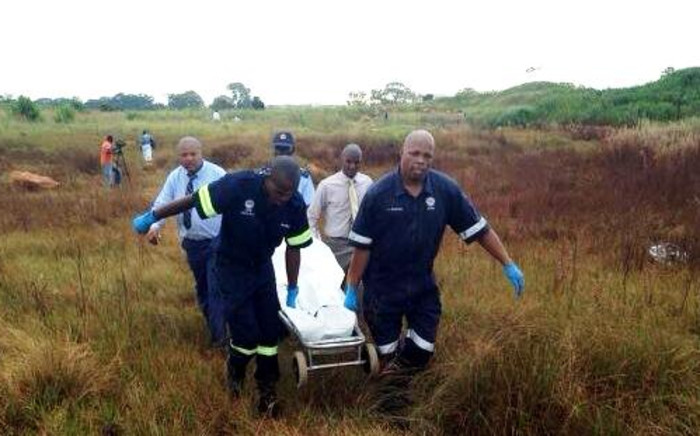 FILE: Forensic pathologists carry the body of one of the girls found dead in Dobsonville, Soweto on 19 February 2014. Picture: Maego Rahlaga/EWN.