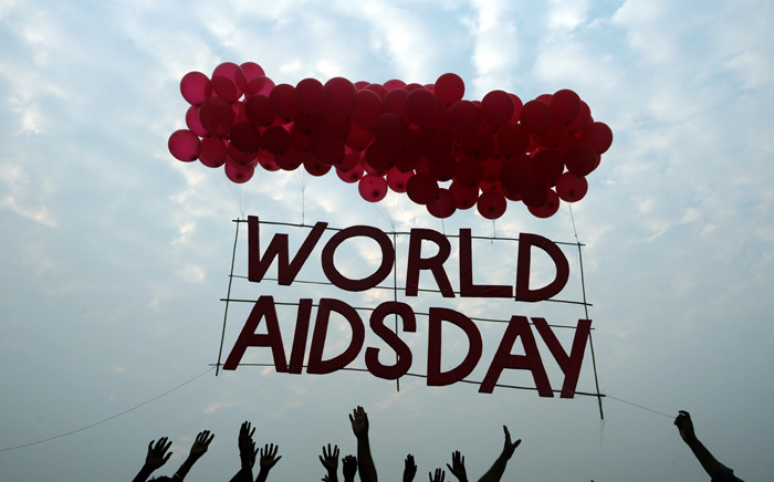 FILE: Indian social activists and children release a World AIDS Day awareness sign tied with ballons in Kolkata on 1 December, 2015. Picture: AFP.