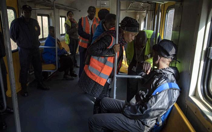 A commuter is interrogated by a Prasa official about his ticket on 28 May 2018. Picture: Thomas Holder/EWN