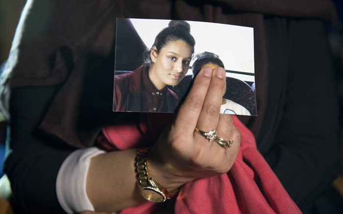 In this file photo taken on 22 February 2015 Renu Begum, eldest sister of British girl Shamima Begum, holds a picture of her sister while being interviewed by the media in central London. Picture: AFP