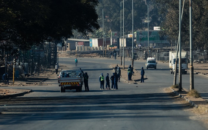 Zimbabwe police ask for travel documents at a road block in Harare 31 July 2020 where they were deployed following a ban on anti-government protests planned for the same day by Zimbabwe opposition political leader Jacob Ngarivhume who has since been detained in custody pending an application for bail. Picture: AFP