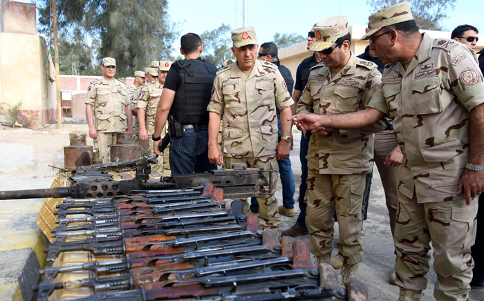 A handout picture released by the Egyptian Presidency on 4 July, 2015, shows Egyptian President Abdel Fattah al-Sisi (2nd from R) reviewing military equipment during a visit to the Sinai Peninsula following a wave of deadly attacks on armed forces by the Islamic State jihadists. Picture: AFP.
