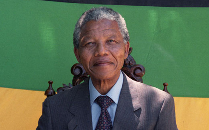 Anti-apartheid leader and African National Congress (ANC) member Nelson Mandela smiles as he poses during a photo session after his first press conference since his release from jail on 12 February 1990 in Cape Town. Picture: AFP.