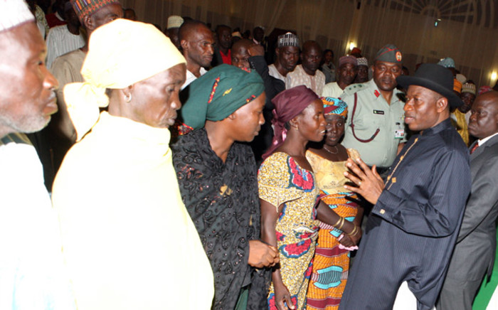 FILE: Nigerian President Goodluck Jonathan (R) speaks to some of the Chibok schoolgirls who escaped Islamist captors and relatives of the hostages during a meeting at the presidency in Abuja on 22 July, 2014. Picture: AFP.