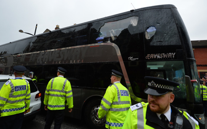 The bus carrying the Manchester United team is escorted by police after having a window smashed on its way to West Hams Boleyn ground before the English Premier League football match between West Ham United and Manchester United in in east London on 10 May, 2016. Picture: AFP.
