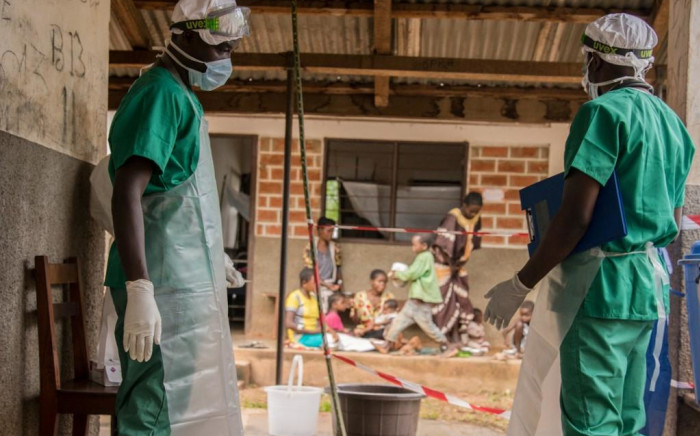 Medical staff wearing protective equipment enter the quarantine area of the centre of the NGO Doctors Without Borders in Zomea Kaka in the Central African Republic to combat monkeypox in 2018.