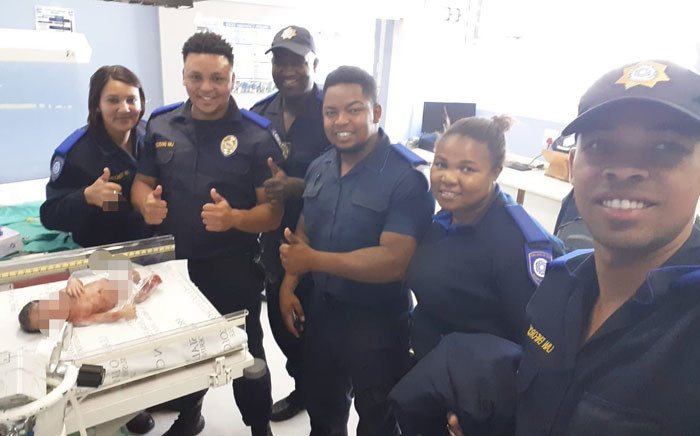 Officers are seen with the newborn baby girl at the Mitchells Plain day hospital. Picture: Supplied.