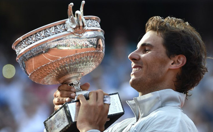 Spain’s Rafael Nadal holds the Musketeers trophy after winning the French tennis Open men’s final match against Serbia’s Novak Djokovic at the Roland Garros stadium in Paris on 8 June, 2014. Picture: AFP. 