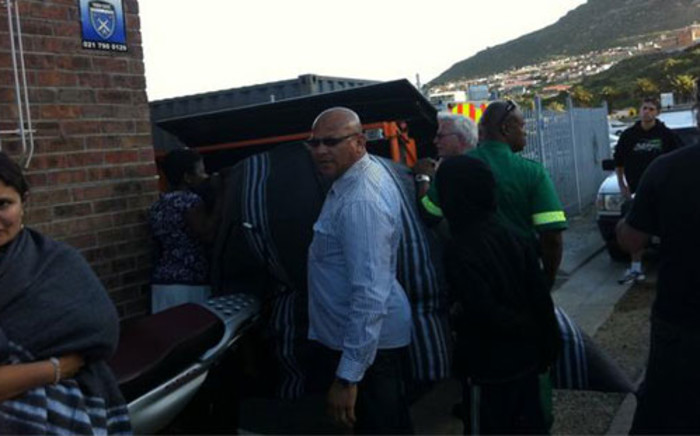 Forensic pathologists arrive to remove the body of a man who drowned when the Marashka boat capsized in Hout Bay on 13 October 2012. Picture: Malungelo Booi/EWN