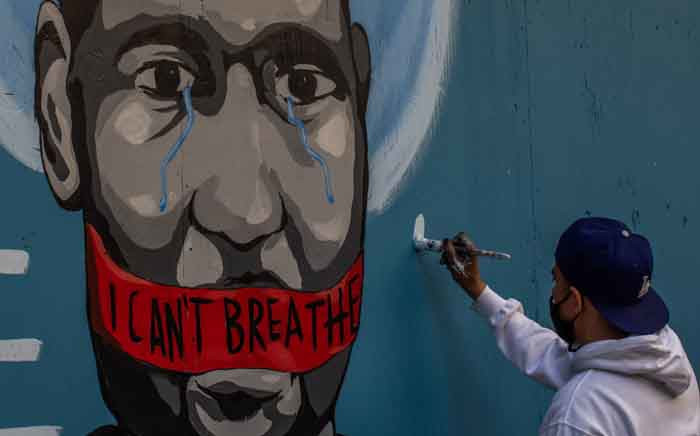 The artist Celos paints a mural in downtown Los Angeles on 30 May 2020 in protest against the death of George Floyd, an unarmed black man who died while while being arrested and pinned to the ground by the knee of a Minneapolis police officer. Picture: AFP