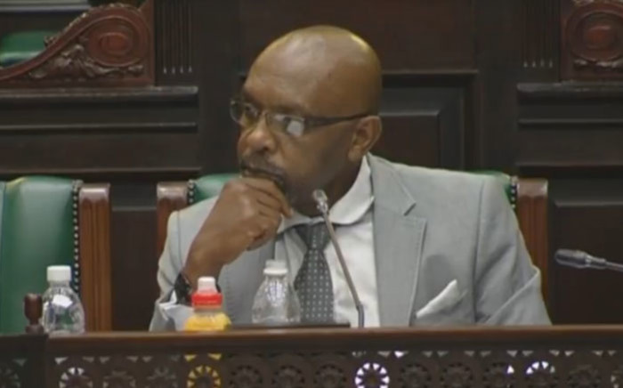 A video screengrab shows Vincent Smith listening to deliberations in Parliament. 
