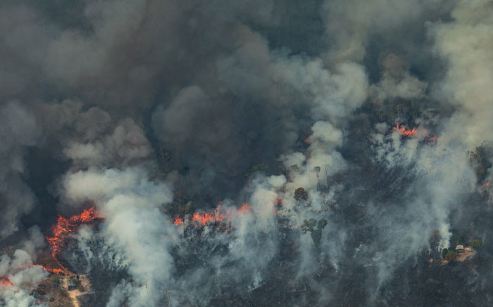 Handout aerial picture released by Greenpeace showing smoke billowing from forest fires in the municipality of Candeias do Jamari, close to Porto Velho in Rondonia State, in the Amazon basin in northwestern Brazil, on 24 August 2019. Picture: AFP