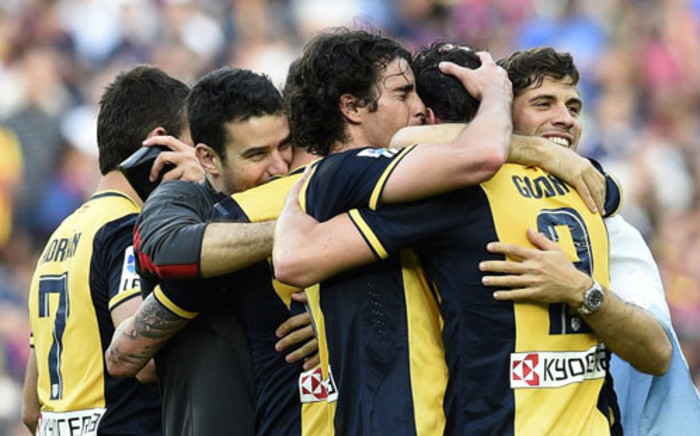 Atletico de Madrid’s football players celebrate their Spanish league title at the end of the Spanish league football match FC Barcelona vs Club Atletico de Madrid at the Camp Nou stadium in Barcelona on May 17, 2014. Picture: AFP.