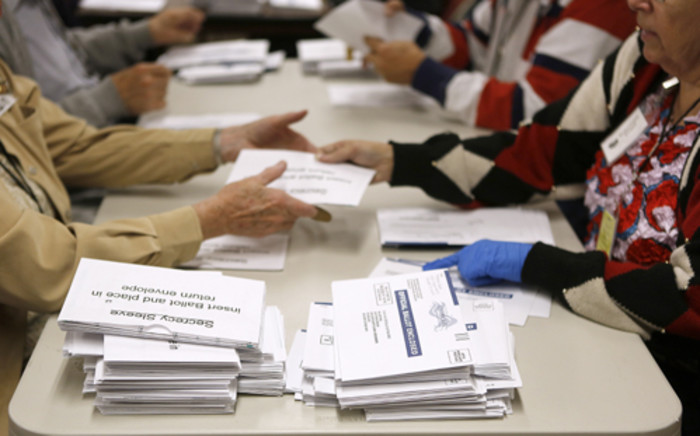 Election workers open mail-in ballots at the Boulder County Clerk and Recorder's Office on November 6, 2012 in Boulder, Colorado.  Picture: AFP