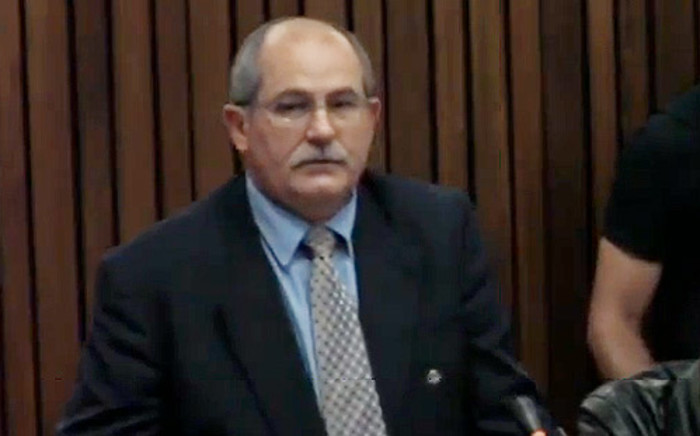 Colonel Schoombie van Rensburg testifies at the High Court in Pretoria during the murder trial of Oscar Pistorius on 13 March 2014.