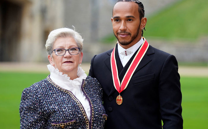 Mercedes driver Lewis Hamilton stands with his mother, Carmen Lockhart, as he poses with his medal after being appointed as a Knight Bachelor (Knighthood) for services to motorsports, by Prince Charles, the Prince of Wales, during an investiture ceremony at Windsor Castle in Windsor, west of London on 15 December 2021. Picture: Andrew Matthews/POOL/AFP