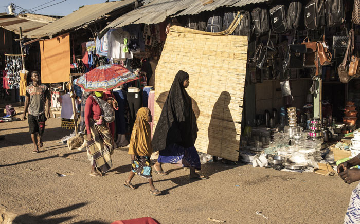 FILE: A woman walks through the central market in Pemba on 25 May 2021. Pemba, the capital of Cabo Delgado, has taken in tens of thousands of people fleeing from violence wreaked by Islamist insurgents across the northern province of Mozambique for over three years. Picture: JOHN WESSELS/AFP