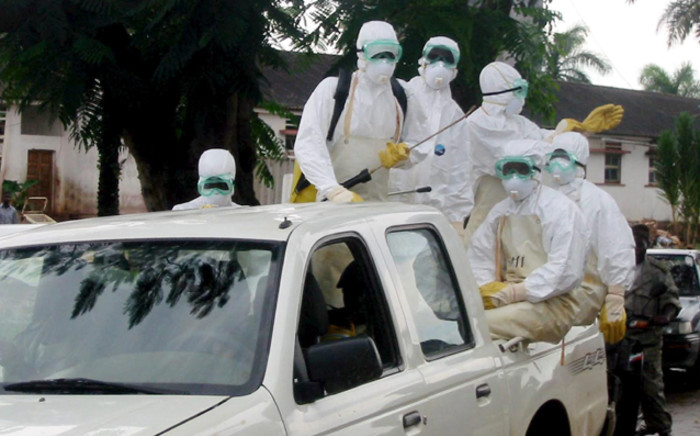 Hygiene officials prepare to disinfect an area after the removal of dead bodies, victims of the Marburg virus, at the Uige Provincial Hospital, north Angola, on 15 April 2005. Picture: EPA/FRANCISCO FONTES