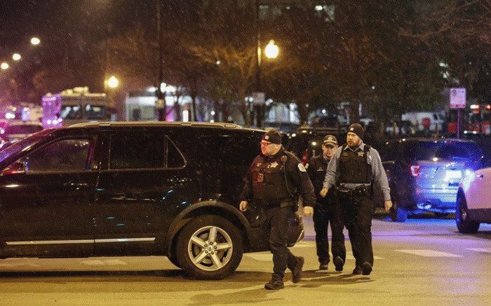 Chicago Police officers monitor the area outside of the Chicago Mercy Hospital where a gunman opened fire in Chicago on 19 November, 2018. Picture: AFP.