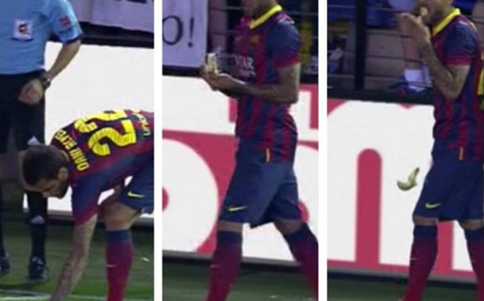 Dani Alves picks up and eats a banana thrown at him during Barcelona's match against Villareal. Picture: Facebook.