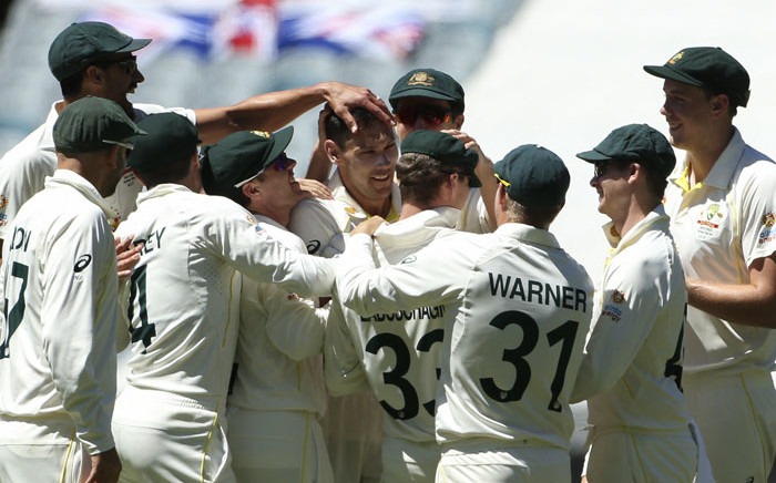 Australia's paceman Scott Boland (C) celebrates the wicket of England's batsman Ollie Robinson (not pictured) with teammates during the third day of the third Ashes cricket Test match in Melbourne on 28 December 2021. Picture: Hamish Blair/AFP