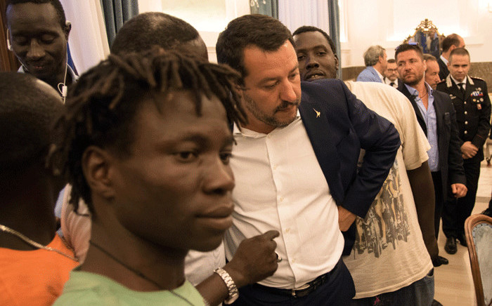 FILE: Italy's Interior Minister Matteo Salvini (C) talks with a delegation of foreign farm labourers in the prefecture of Foggia, southern Italy, on 7 August 2018, a day after a van smashed into a lorry killing 12 migrant agricultural workers on board. Picture: AFP