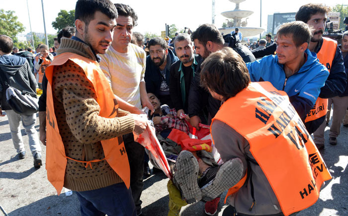 An injured person is carried away following a blast at a peace rally in Ankara on 10 October 2015. Picture: AFP 