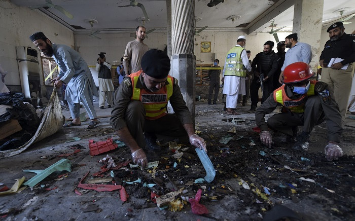 Security officials examine the site of a blast at a religious school in Peshawar on October 27, 2020. At least four students were killed and dozens more wounded on October 27 when a bomb exploded during a class at their religious school in Pakistan, officials said. Picture: AFP