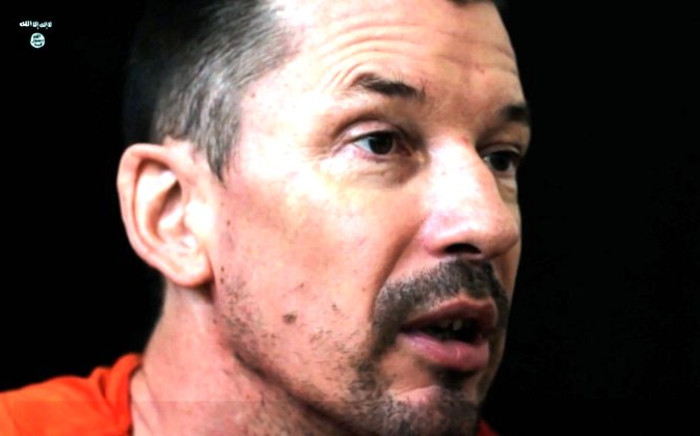 An image grab taken from a video released by the Islamic State organisation through Al-Furqan Media via YouTube on 18 September 2014, allegedly shows British freelance photojournalist, John Cantlie, at an undisclosed location in which he says he is being held captive. Picture: AFP.