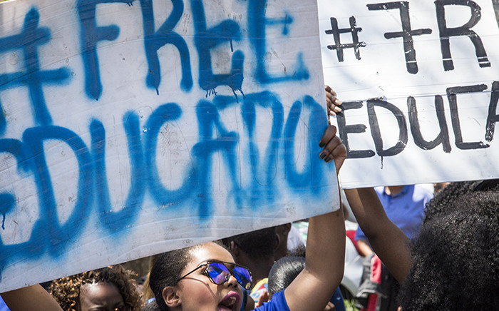 FILE: Demonstrating students hold up placards during protests over tertiary education fees in Pretoria. Picture: Reinart Toerien/EWN.