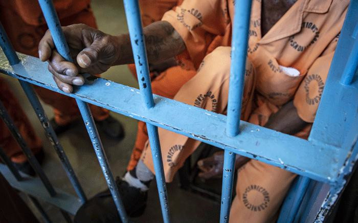 An aged inmate with a tattoo on his hand shares a holding cell with others the Leeuwkop Correctional Facility. Picture: Thomas Holder/EWN. 