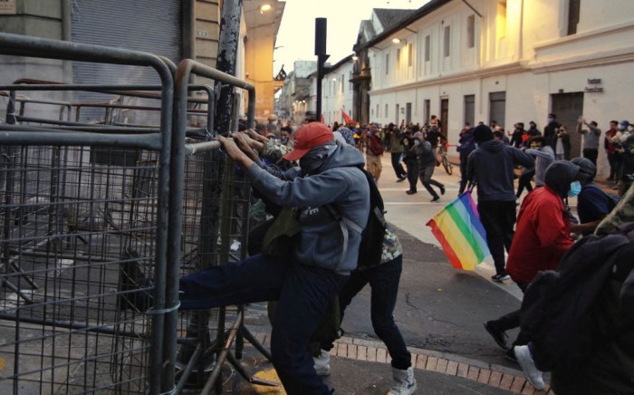 Demonstrators try to tear down a fence in the framework of indigenous-led protests against the government of President Guillermo Lasso that began on Monday, in the surroundings of the Carondelet government palace, in Quito, on June 17, 2022. Ecuador's president met a small group of Indigenous leaders Friday for talks seeking to end countrywide fuel price protests that surrounded the capital Quito with road blockades for a fifth day.