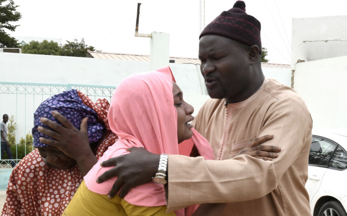 Family members console each other outside the Mame Abdoul Aziz Sy Dabakh Hospital, where eleven babies died following an electrical fault, in Tivaouane, on May 26, 2022. Picture: SEYLLOU / AFP