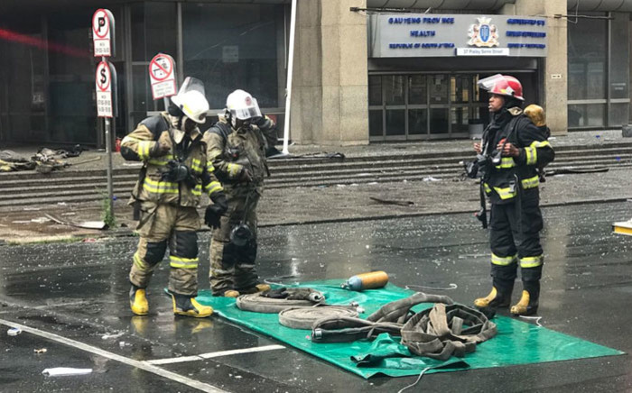 Firefighters begin clearing away equipment on 7 September 2018 near the Lisbon Building following the deadly fire there earlier this week. Picture: Christa Eybers/EWN
