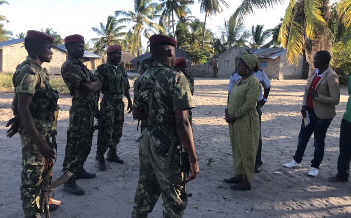 Mozambican Army personnel talks with Nuance Mayor, Joaquina Nordine (3rdR), in Naunde, northern Mozambique, on 13 June, 2018. Picture: AFP