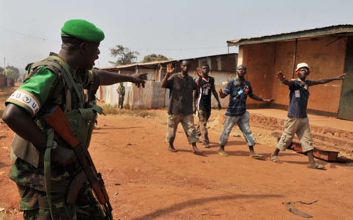 Rwanda soldier from the African-led International Support Mission to the Central African Republic (MISCA), gestures as he patrols on 22 January, 2014 in the Pk 13 district, north of Bangui, after after an attack by anti-Balaka fighters. Picture: AFP.