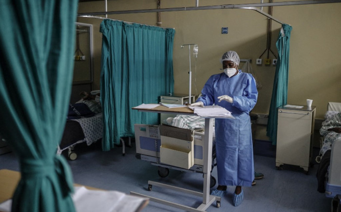 FILE: Nurse Salome Nkoana, acting operational manager of COVID-19 ward at the Tembisa Hospital, checks the history of a patient infected with COVID-19 in Tembisa, on March 2, 2021. Picture: Guillem Sartorio / AFP