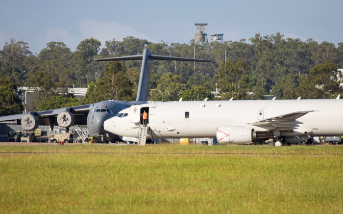 This handout photo taken and released by the Royal Australian Air Force and the Australian Defence Force shows a Royal Australian Air Force P-8 Poseidon aircraft (R) preparing to depart from RAAF Base Amberley in the state of Queensland to assist the Tonga Government after the eruption of the Hunga-Tonga - Hunga-Haa'pai volcano on 15 January 2022. Picture: Australian Defence Force/AFP