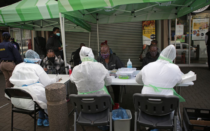 FILE: City of Tshwane Health officials conduct screening exercises on people before some of them will be tested for the COVID-19 coronavirus at the Bloed Street Mall in Pretoria Central Business District. Picture: AFP
