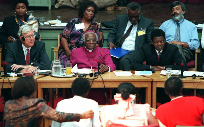 FILE: Then Archbishop Desmond Tutu (centre) with fellow commissioners listen to testimony from witnesses during the start of the Truth and Reconciliation Commission which opened in East London, 15 April 1996. Picture: AFP.