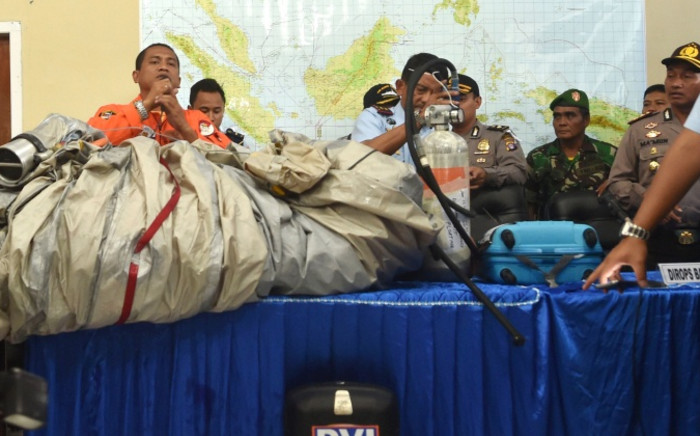 Members of the Indonesian air force show items retrieved from the Java sea during search and rescue operations for the missing AirAsia flight QZ8501, in Pangkalan Bun, Central Kalimantan on December 30, 2014. Picture: AFP.
