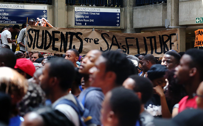 Wits students hold up a banner inside Senate House on 19 October 2015 during protests over proposed fee increases at the institution for the 2016 year. Picture: Reinart Toerien/EWN.