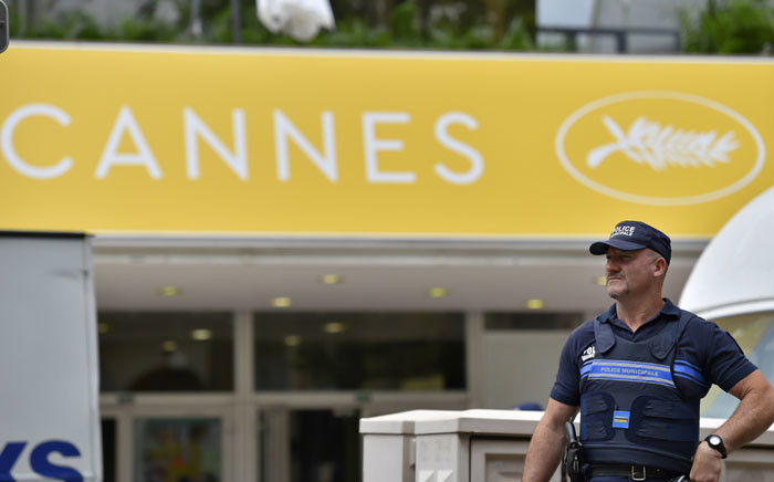 A French police officer stands guard in front of the Festival Palace in Cannes on 10 May 2016, on the eve of the beginning of the 69th Cannes film festival. Picture: Loic Venance/AFP.