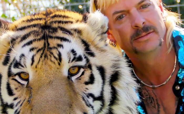 In this file photo taken on 20 January 2020 this undated photo courtesy of Netflix shows Joseph "Joe Exotic" Maldonado-Passage with one of his tigers. The US Justice Department said 20 May 2021 that it had seized 68 lions, tigers and lion-tiger hybrids as well as a jaguar from the former animal park of Joe Exotic, the star of the Netflix hit 'Tiger King'. Picture: AFP