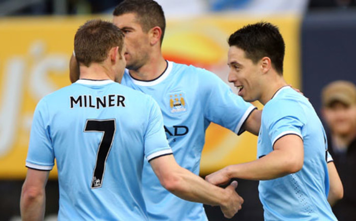 Manchester City’s Samir Nasri is congratulated by James Milner and Edin Dzeko after he scored a goal against Chelsea at Yankee Stadium in New York on 25 May 2013. City beat Chelsea 5-3. Picture: AFP