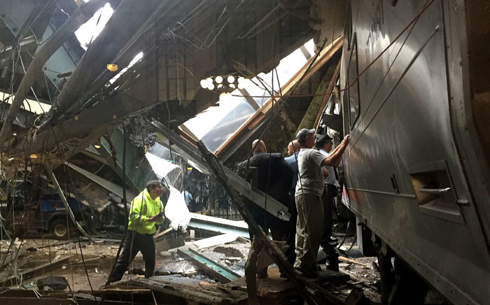 FILE: Train personnel survey the NJ Transit train that crashed in to the platform at the Hoboken Terminal 29 September 2016 in Hoboken, New Jersey. Picture: AFP.
